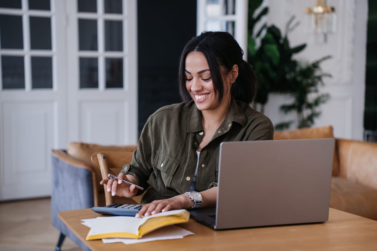 A woman working at her computer for her business, The Valley List is here to help with your Agency white label support in athens.