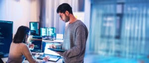 A man and woman works on website maintenance together. The Valley list is here to help.