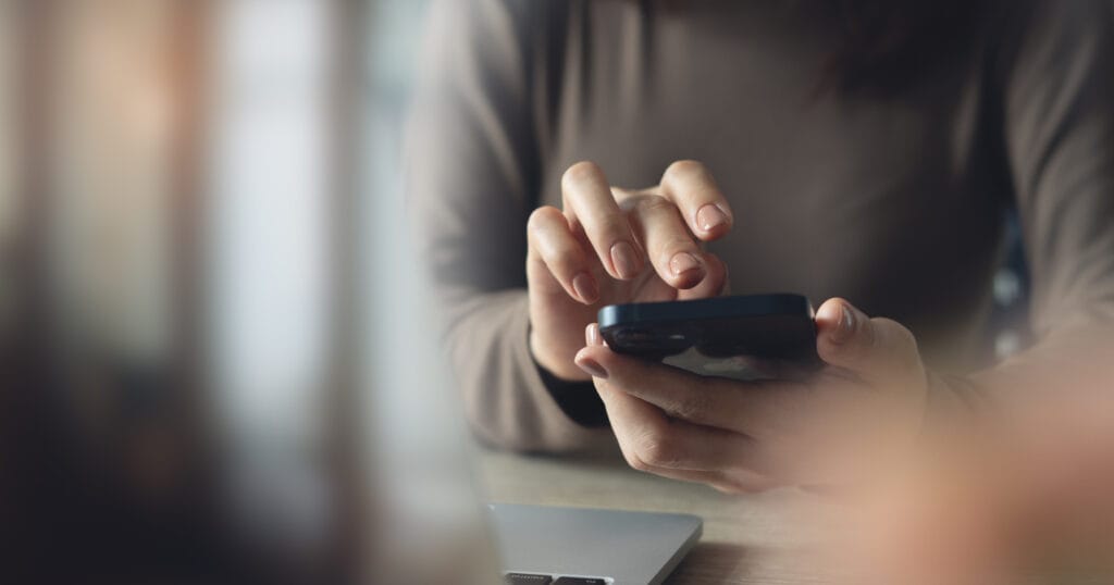 A person using their smartphone to access a site or app.