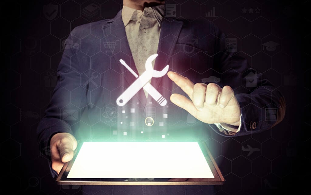 A man touches the "tools" icon above his tablet.