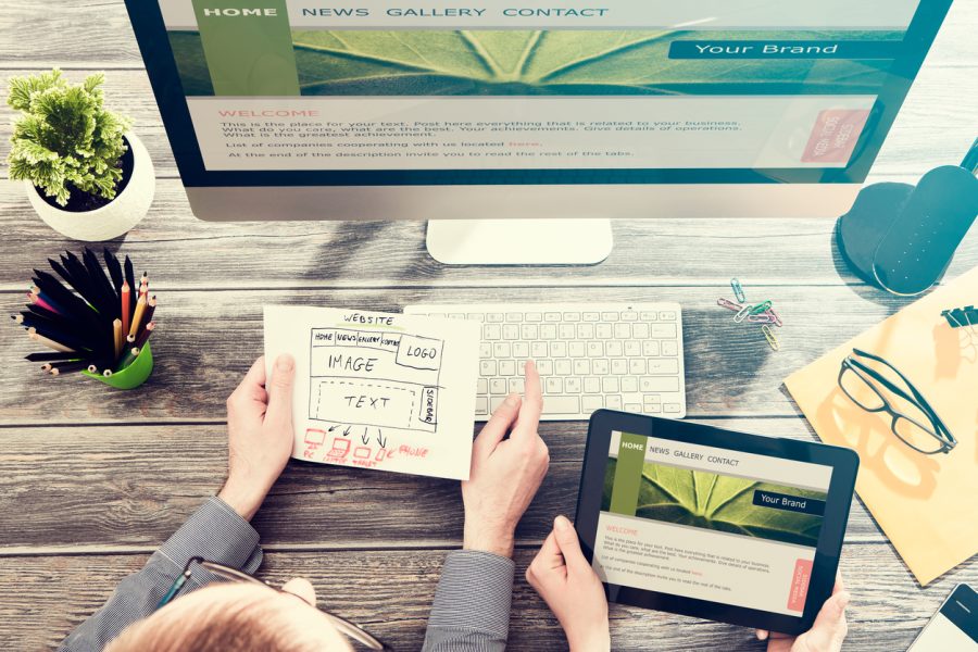Designer's desk with responsive web design concept. Website design in Charleston is something we offer.