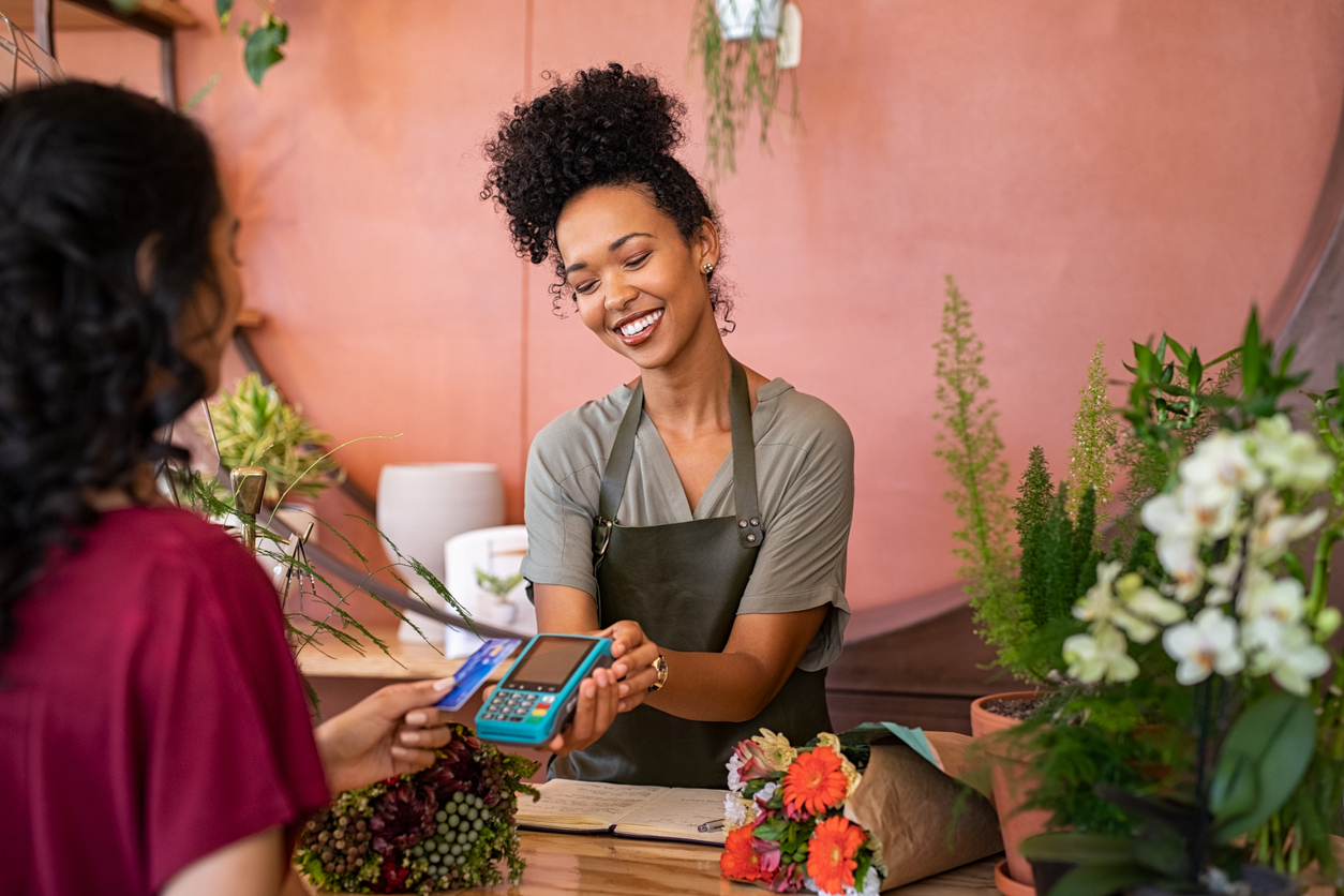 A small local business owner completes a sale with a customer. The Valley List is a trusted provider of website design company in Dublin.