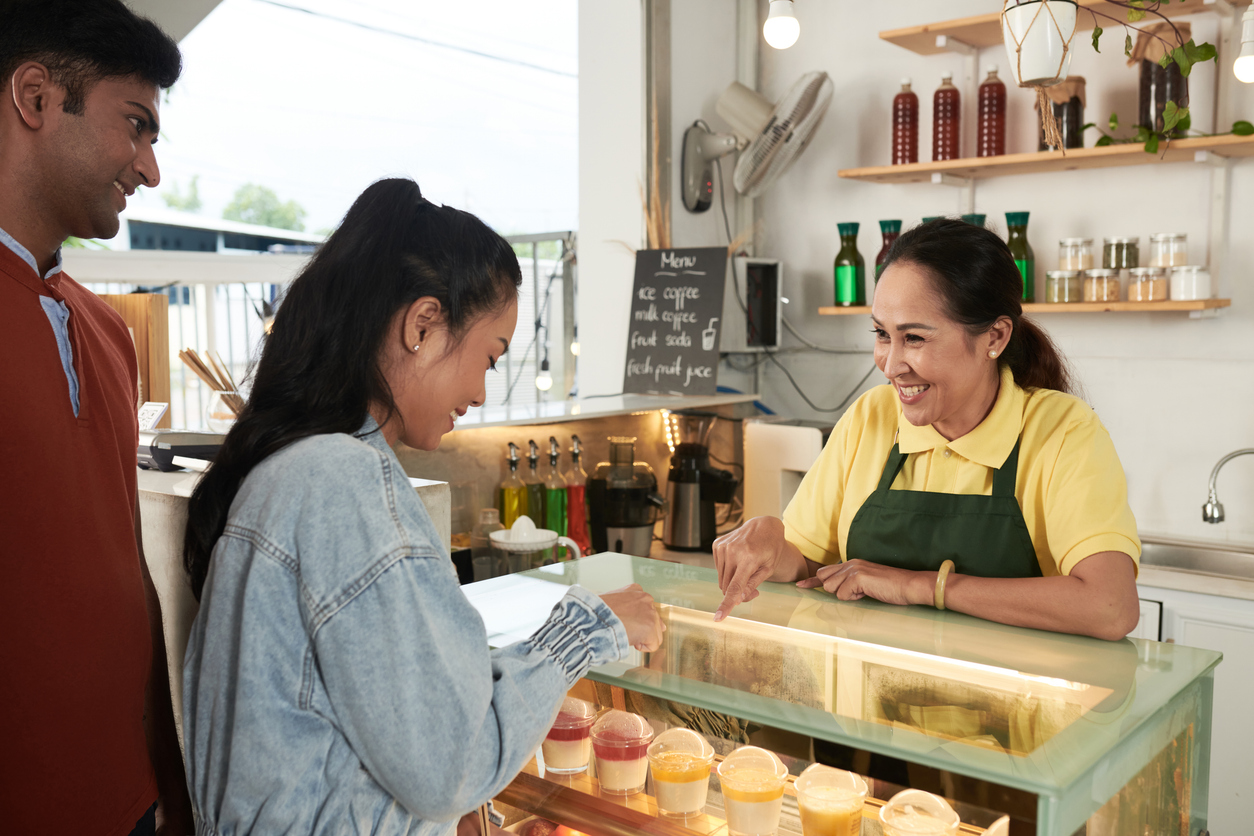 A woman working at a bakery counter helps her customers choose items from her display. The Valley List and Web Impact Marketing have partnered together to become an affordable SEO company in Bexley Ohio.