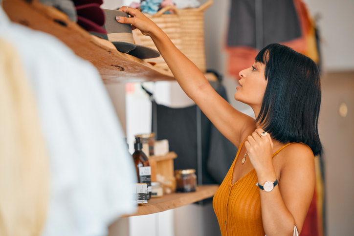 A woman shops at a boutique store, she is wearing a golden yellow dress. For all your web hosting in Seguin, Texas, needs, contact The Valley List today.