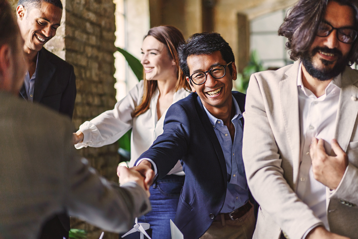 Group of professionals celebrate and shake hands after reaching a goal. The Valley List is a white label agency in Dublin, Ohio, who specialize in app and web development, design, and maintenance.