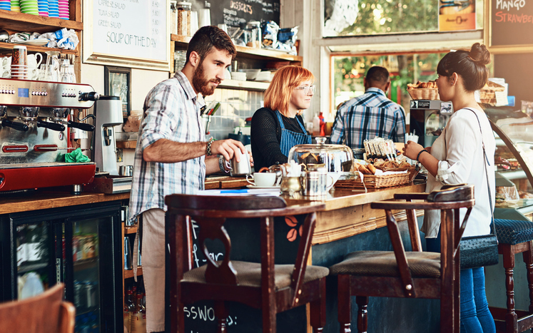 A busy local business, with several individuals shopping inside the store. Every business, small and large, can benefit from custom web development.