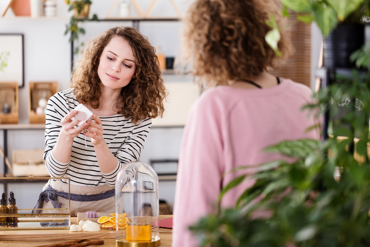 A woman shops in a local store. Small businesses benefit from managed web hosting, and this blog post answers the question "what is web hosting"?