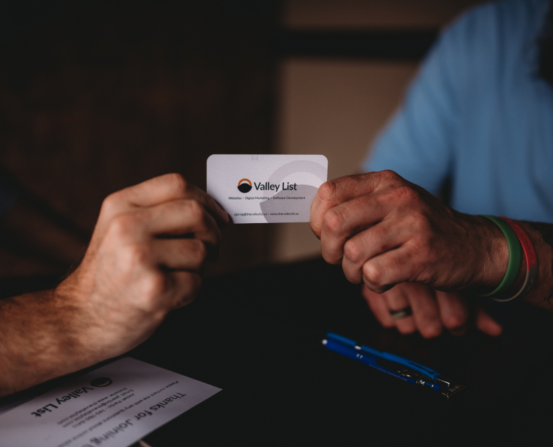 The Valley List team holding business card in Ohio to represent local web design services
