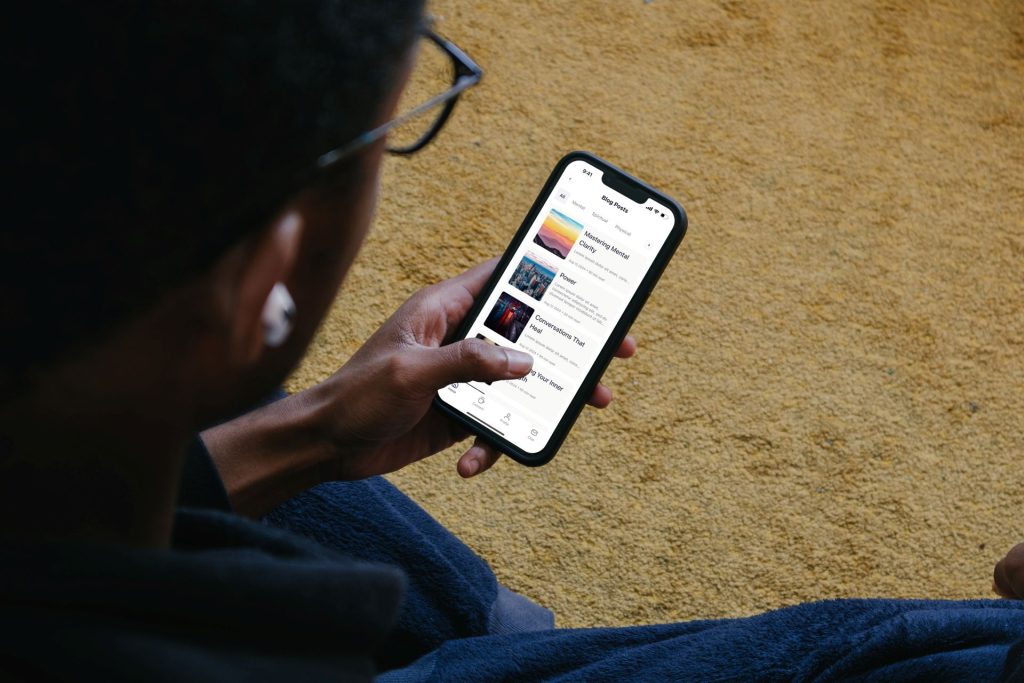 A person looks at the mobile app created by The Valley List for churches and community, known as The Hub.