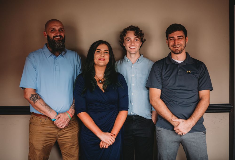 A photo of four of our Team Members - Chris, Kate, Carson, and Josiah. Contact Us today.