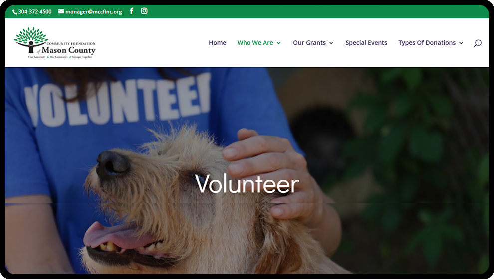 The home page for Mason County Community foundation. A photo of a person with a blue shirt that says "volunteer" on it, and is holding a dog, is the hero image.